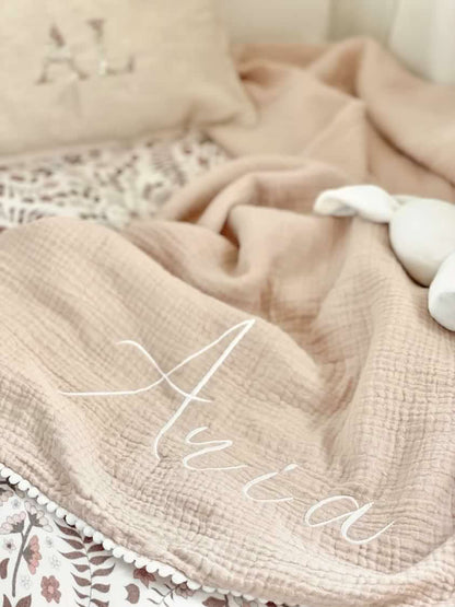 ORGANIC MUSLIN BLANKET WITH POM POMS